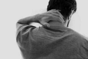 Person complaining of a stiff neck after sleeping