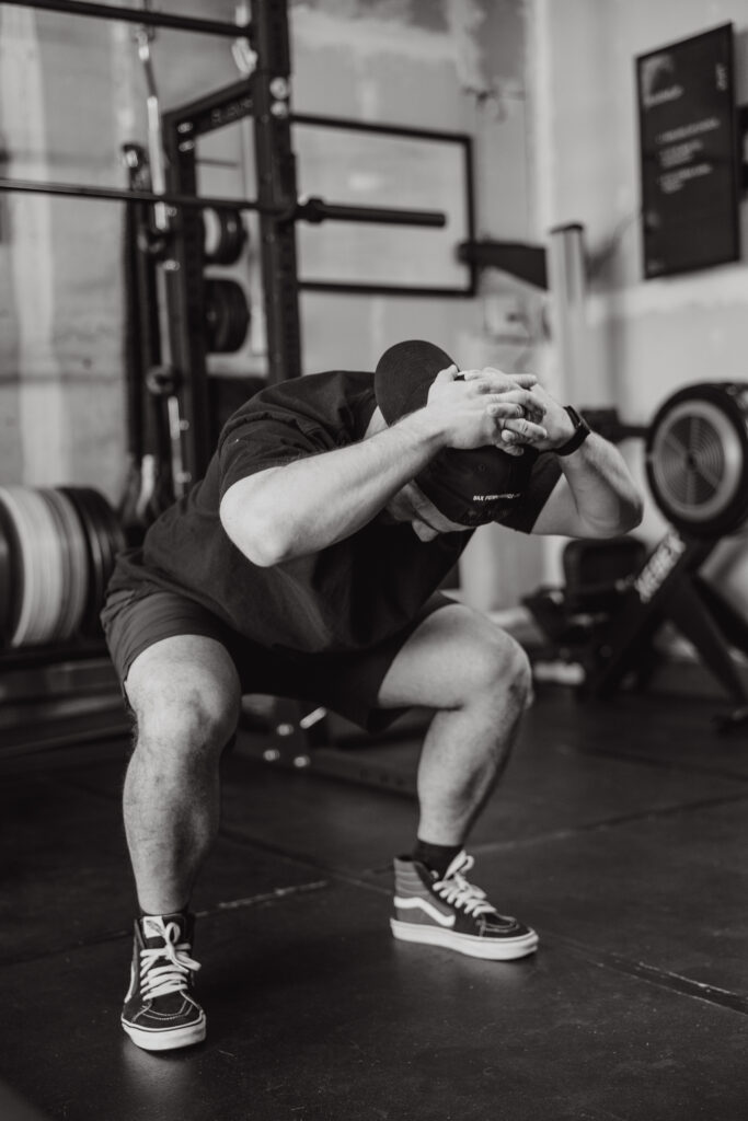 Physical therapist demonstrating squat for to minimize knee pain