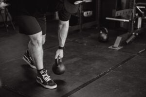 Athlete with low back pain learning hip exercises to rehab from pain