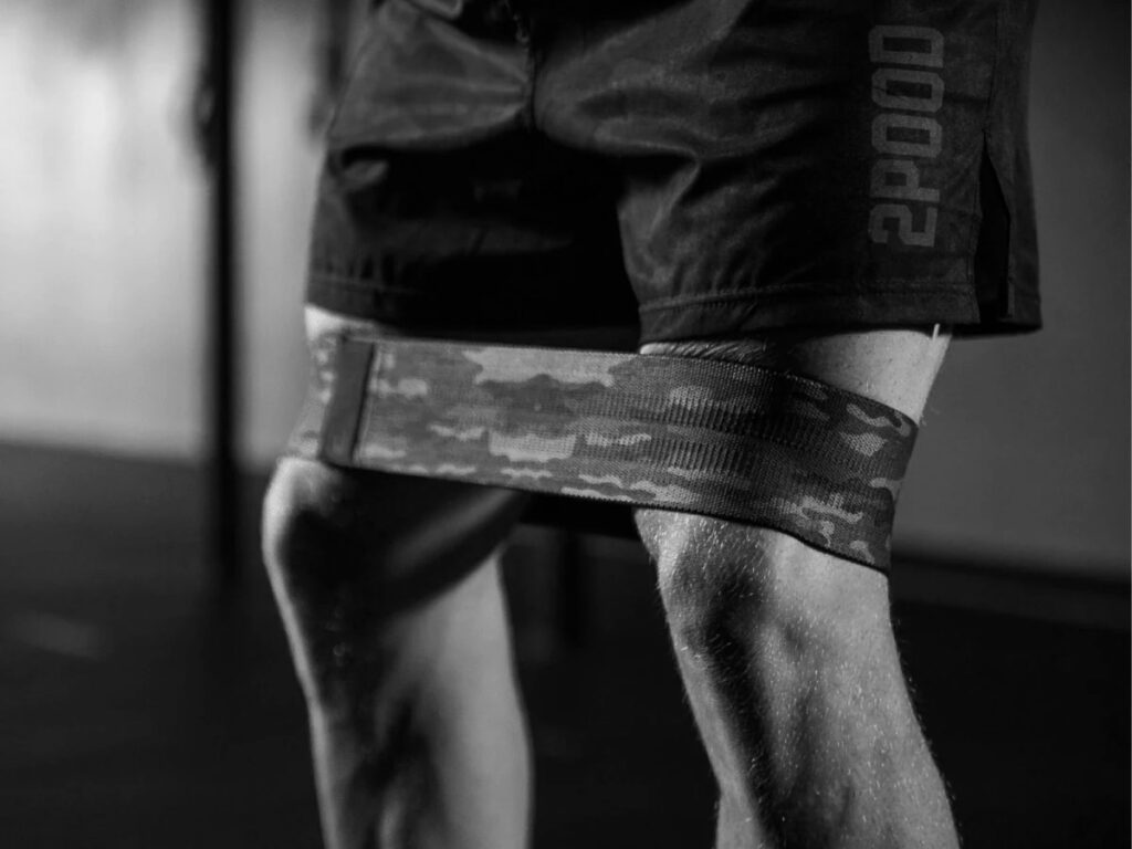 Athlete warming up and stretching hips prior to workout